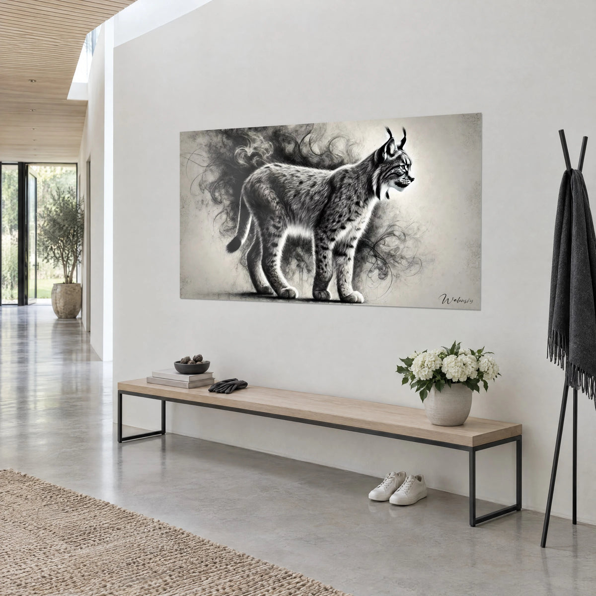 Wall art wild cat in black and white charcoal, black-tipped tail, grainy cream background, on a white wall above a wooden bench