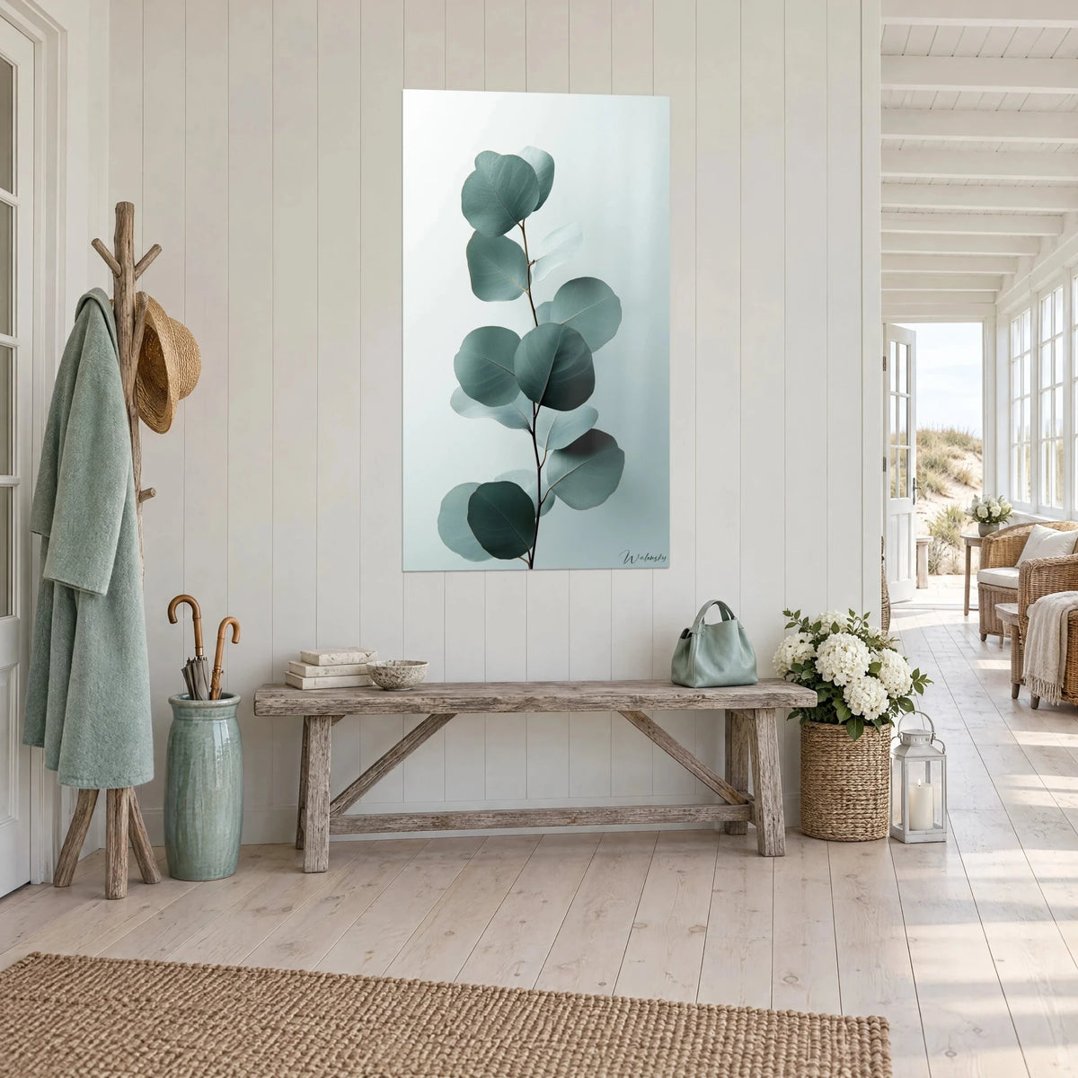 Wall art sprig with silvery leaves in sage green and pale grey, hanging in a whitewashed wood hallway with a seaside feel