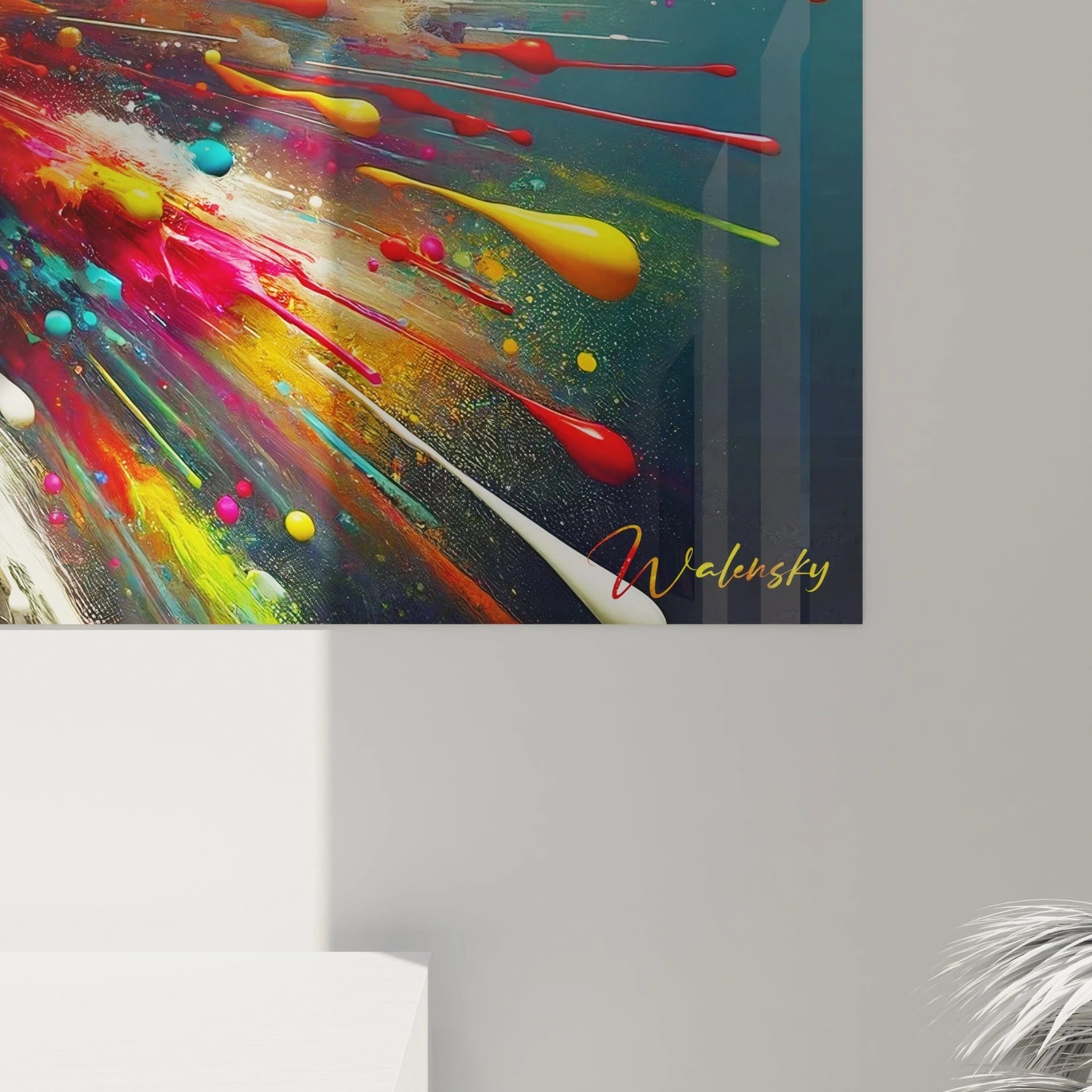 Tableau abstrait présentant un big bang coloré sur fond bleu-noir. Mélange vibrant de couleurs vives avec dominantes de rouge, jaune, cyan, magenta et blanc. Effet visuel obtenu par projection de peinture liquide formant des gouttes, éclaboussures et traînées. Composition symétrique avec point focal central et rayonnement multicolore créant une impression d'explosion instantanée.