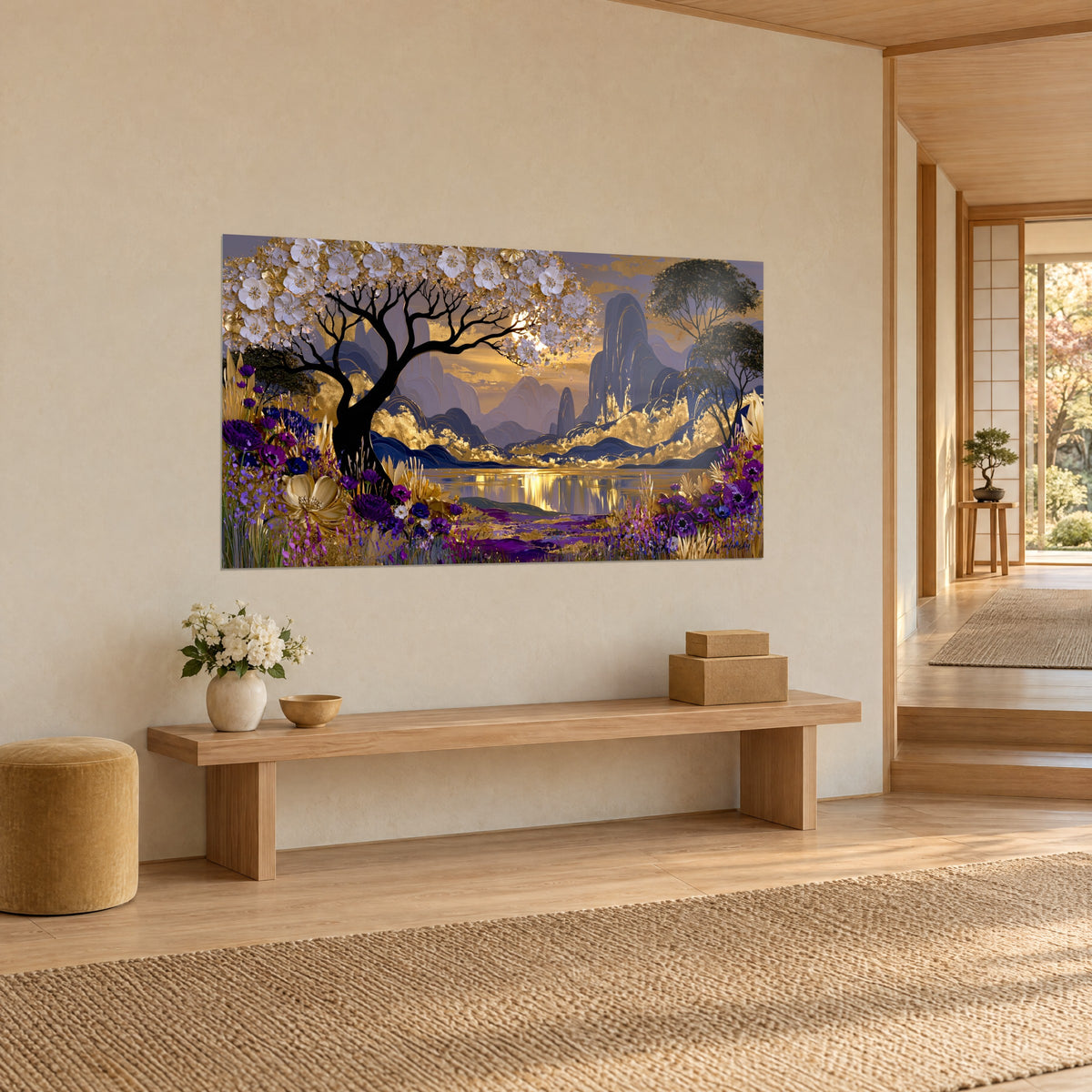 Wall art of a mauve mountain landscape under a golden sky, black branches and white petals, light wooden bench, three-quarter view