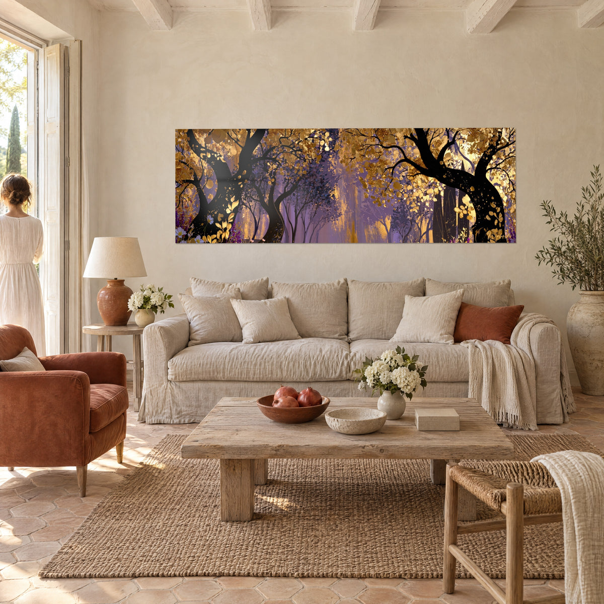 Wall art canopy of golden treetops on a purple background, twisting black trunks, white flowers, above a sofa in a bright living room