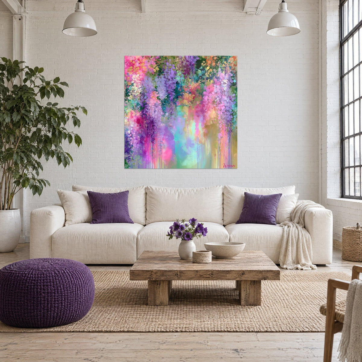 Wall art with fuchsia and mauve wisteria clusters with turquoise drips, above a sofa in a bright living room