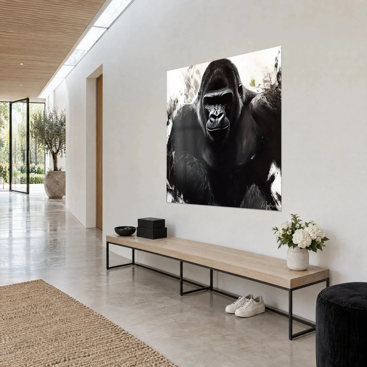 Quadro di primate massiccio in inchiostro nero su fondo crema, schizzi grigi, vista di tre quarti sulla parete di un corridoio chiaro