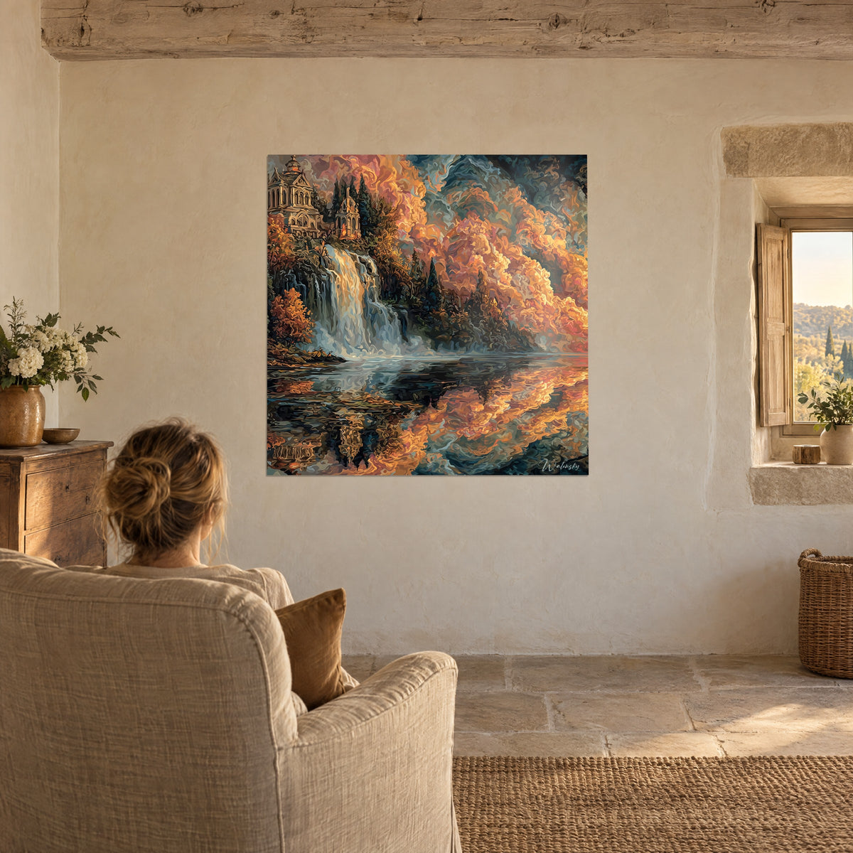 Wall art mirror lake with amber and turquoise reflections, waterfall and castle with gothic arches, facing a beige armchair near a window