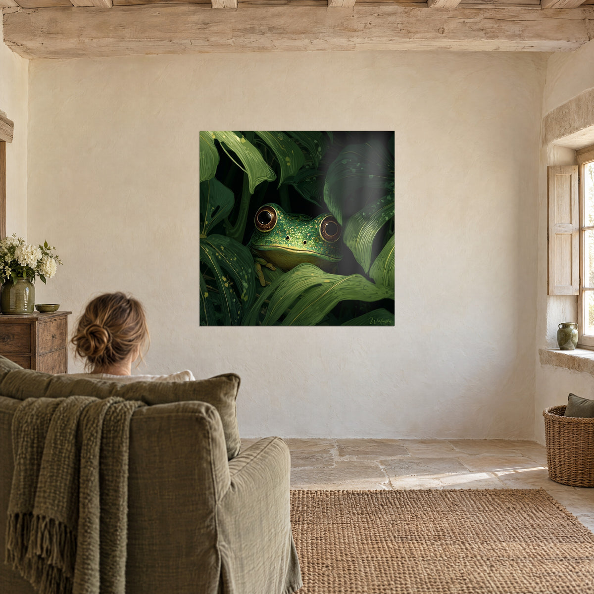 Wall art of a jungle creature: green frog with brown irises edged in gold, nestled in dark foliage, facing an olive green armchair