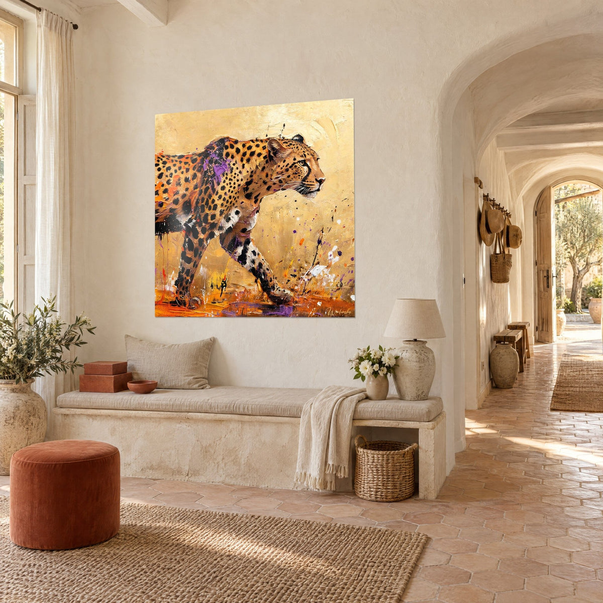 Wall art of a leopard with black rosettes, orange splashes on the floor, sandy background, hung in the vaulted hallway of a Provençal farmhouse