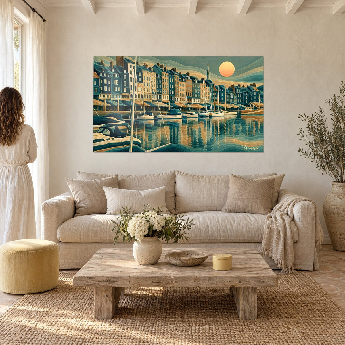 Wall art slate facades of the old harbour basin, orange sun over sage sky, couple seen from behind above a sofa in a bright living room