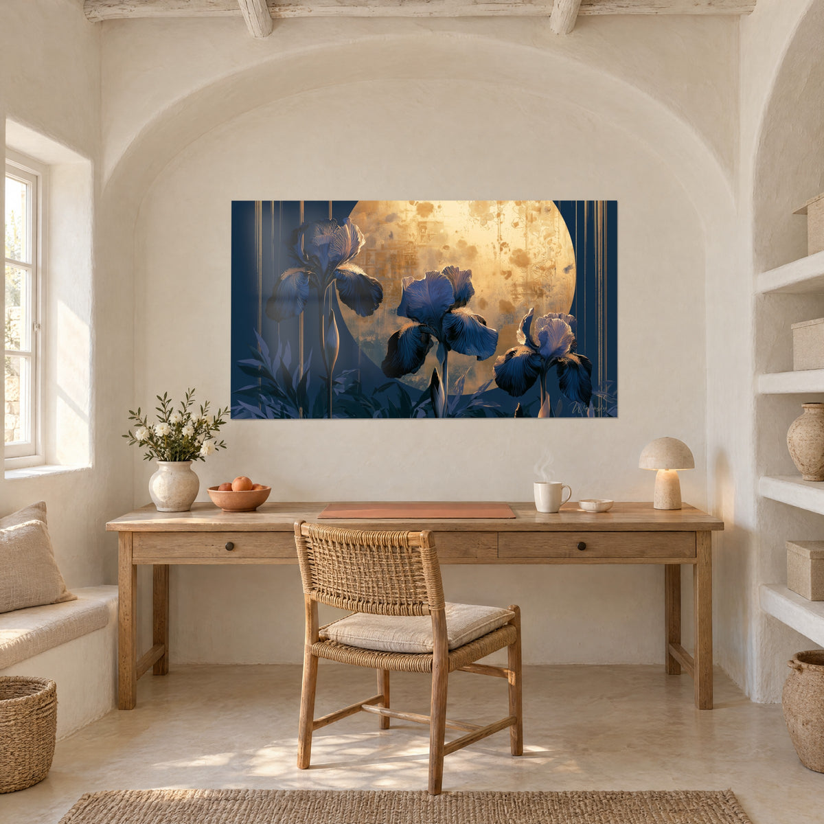 Wall art of an ink-blue iris bloom and mauve foliage under a golden full moon, hung above a light wood desk