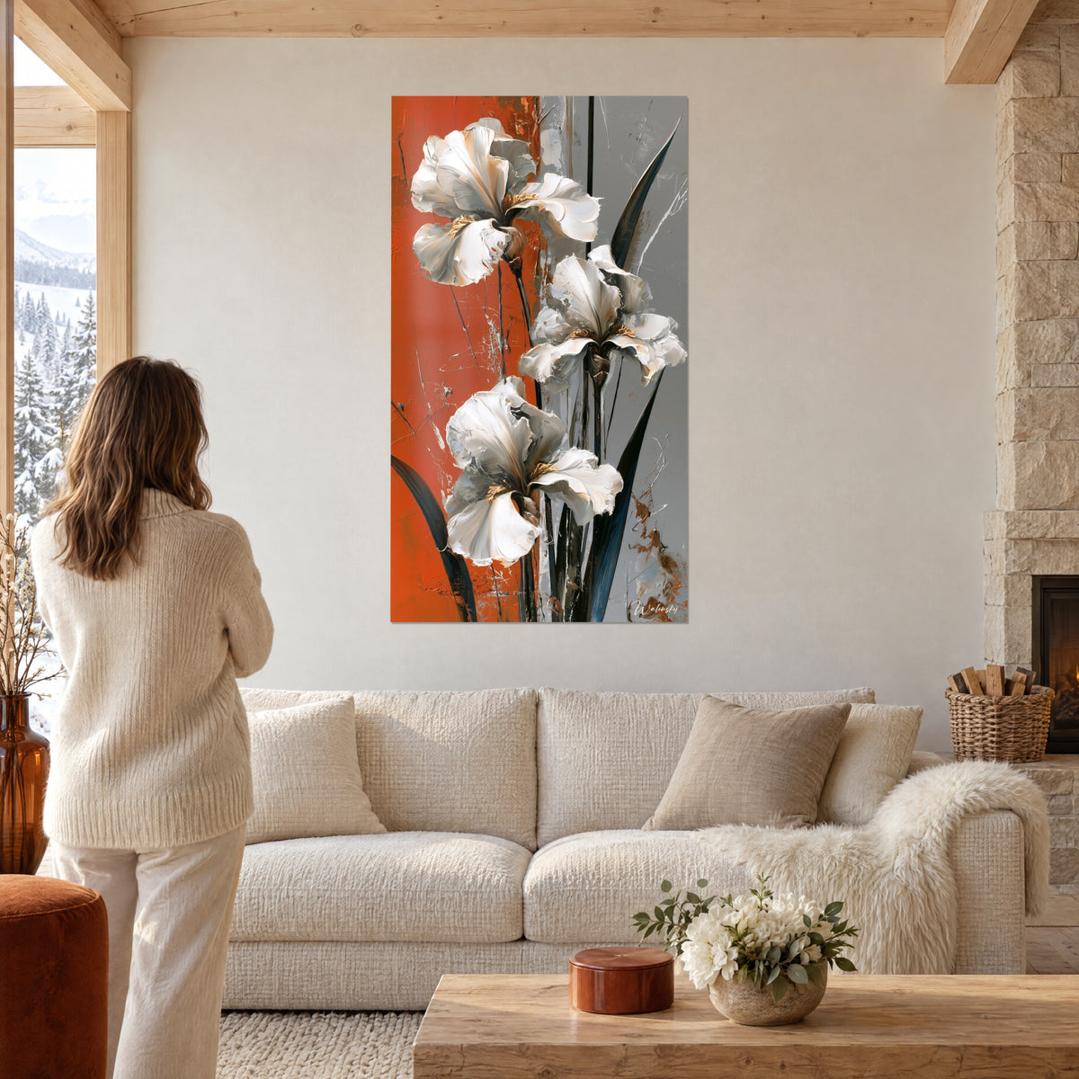 Wall art white irises with thick ivory petals on burnt orange and grey background, woman seen from behind, above a sofa in a bright living room
