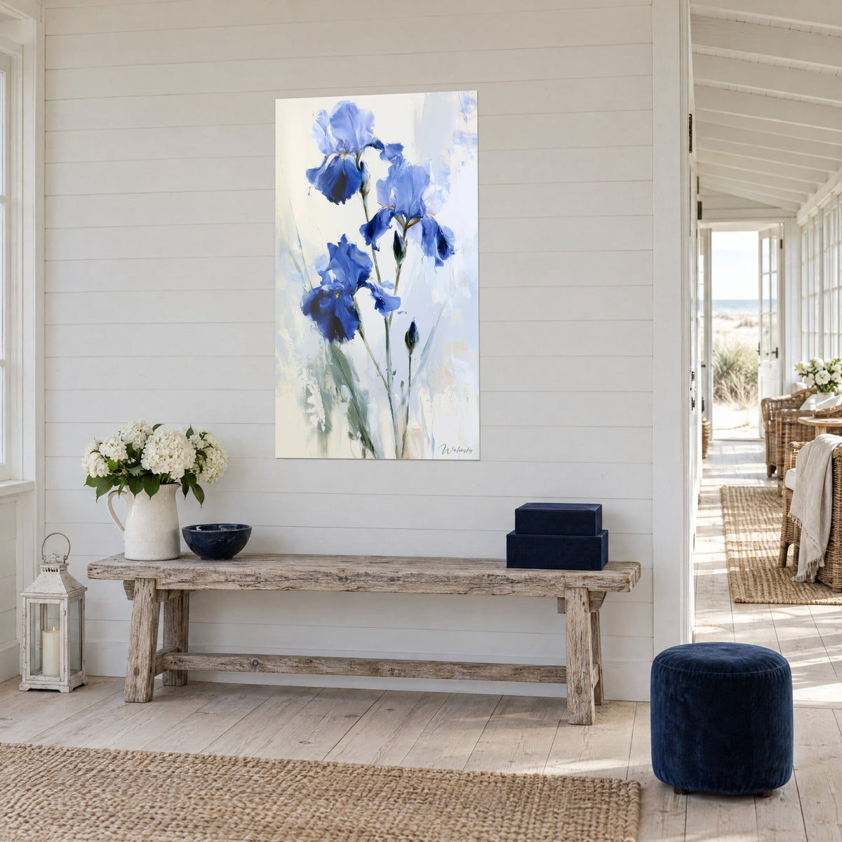 Wall art of indigo and sky blue iris flowers on a cream background, three-quarter view of a whitewashed wooden console