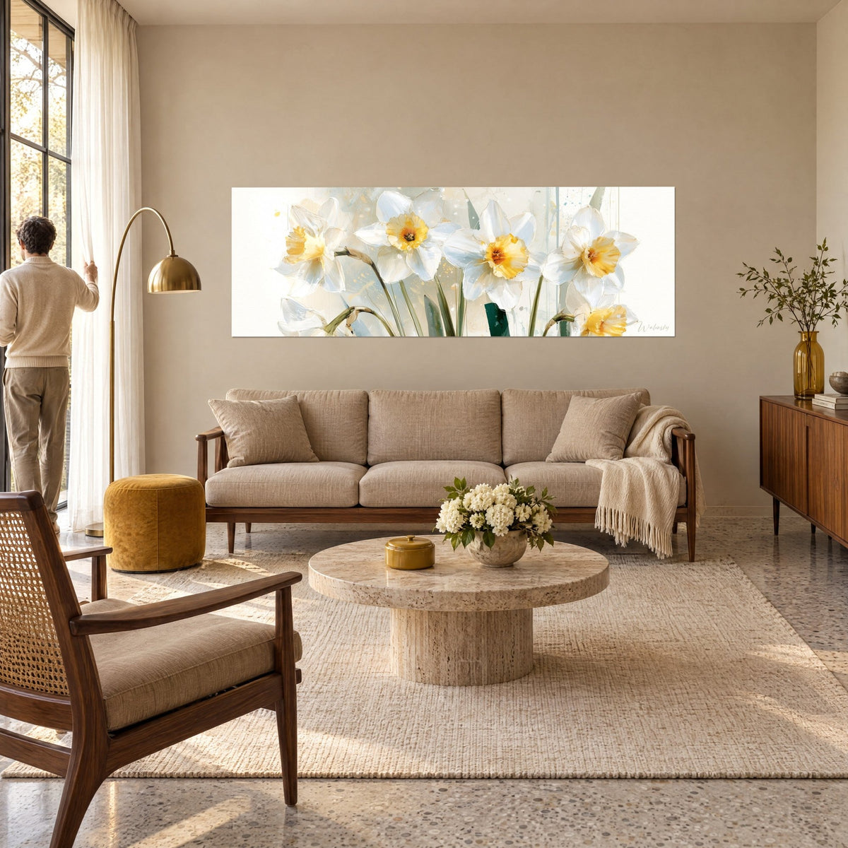 Wall art white daffodils with golden yellow centres and olive green stems, beige splashes, above a sofa in a bright living room