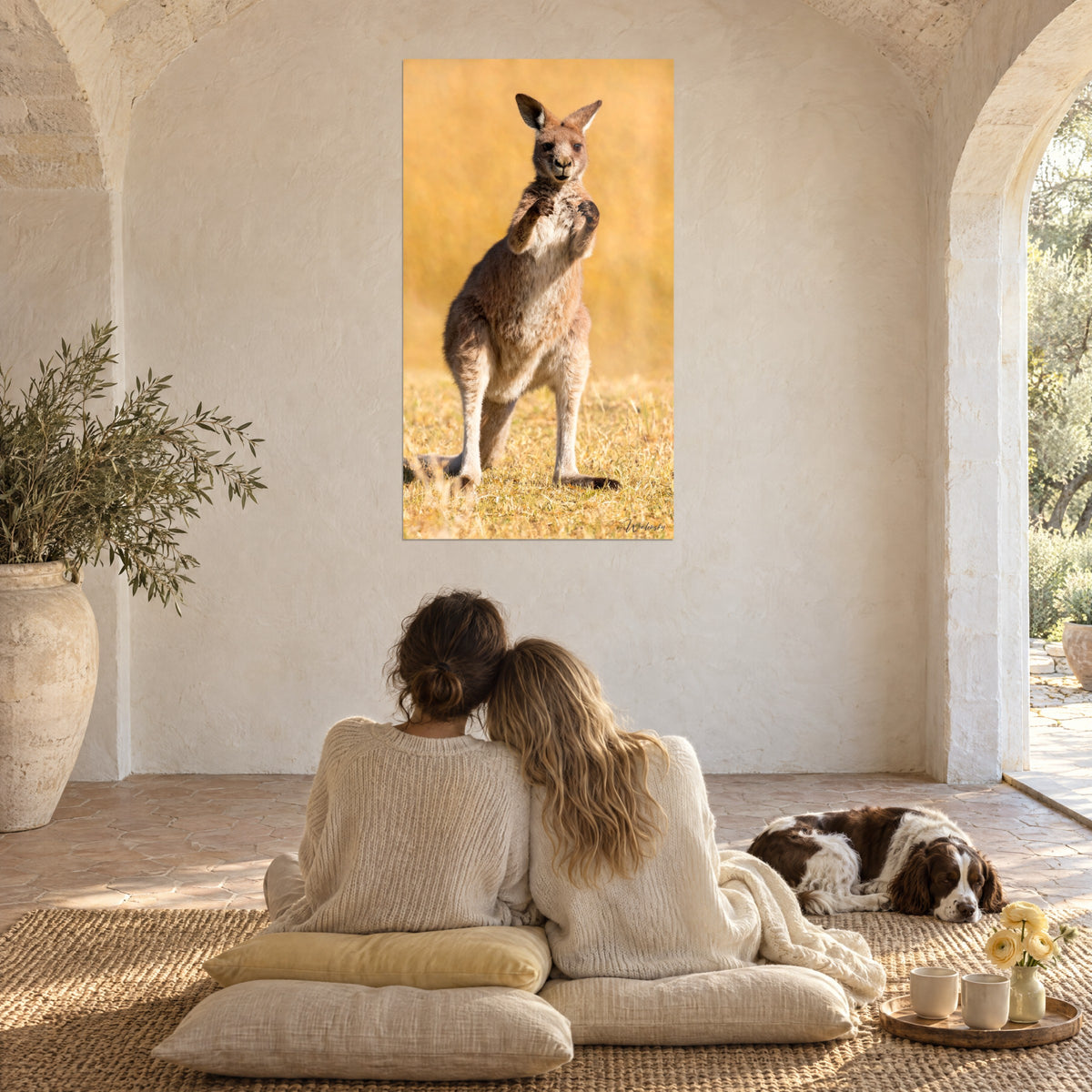 Wall art kangaroo in front-facing profile, sand and brown fur, yellow grass, seen from the floor of a vaulted room with cream walls