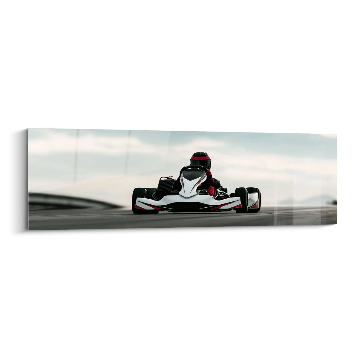 Kart blanc et rouge filant sur piste asphaltée grise, pilote casqué penché en avant