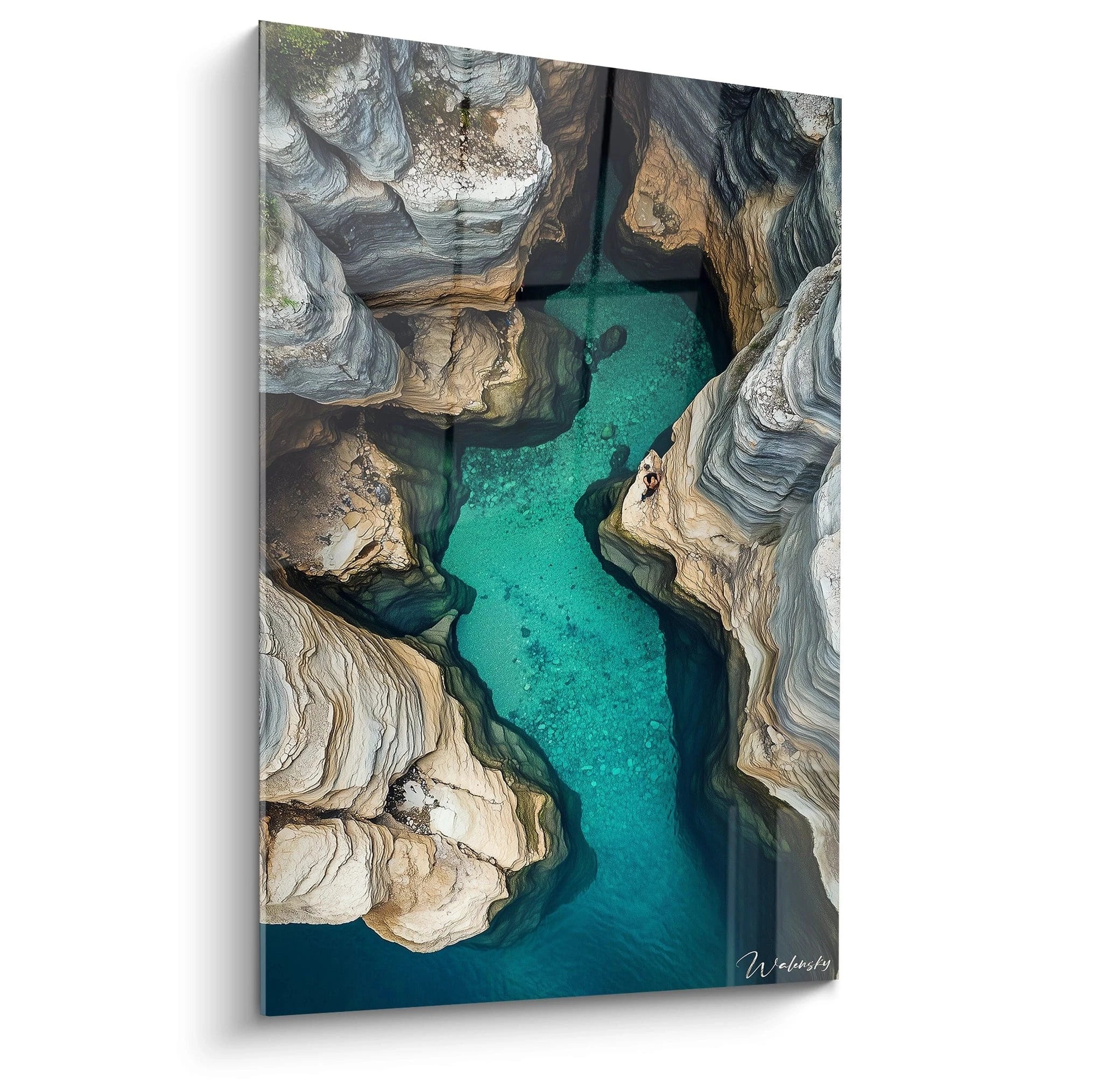 Un tableau paysage capturant une vue aĂ©rienne dâune gorge rocheuse avec une eau turquoise. Les formations rocheuses sont beige et gris, aux textures striĂ©es, contrastant avec la transparence de lâeau.