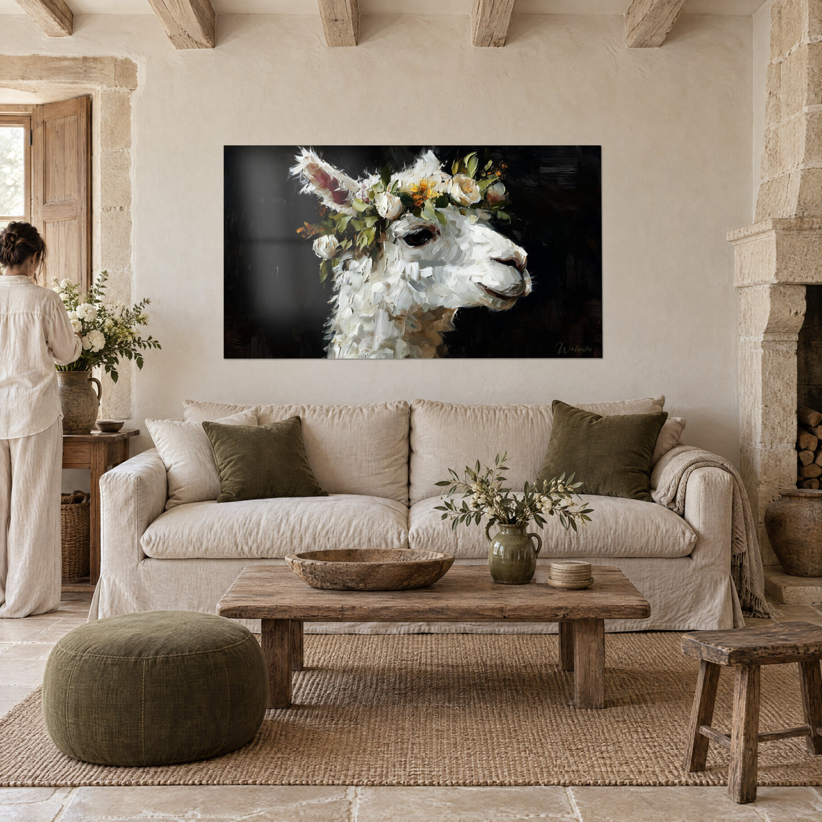 Wall art white llama crowned with ivory roses, black background and green foliage, seen from behind, above a sofa in a bright living room