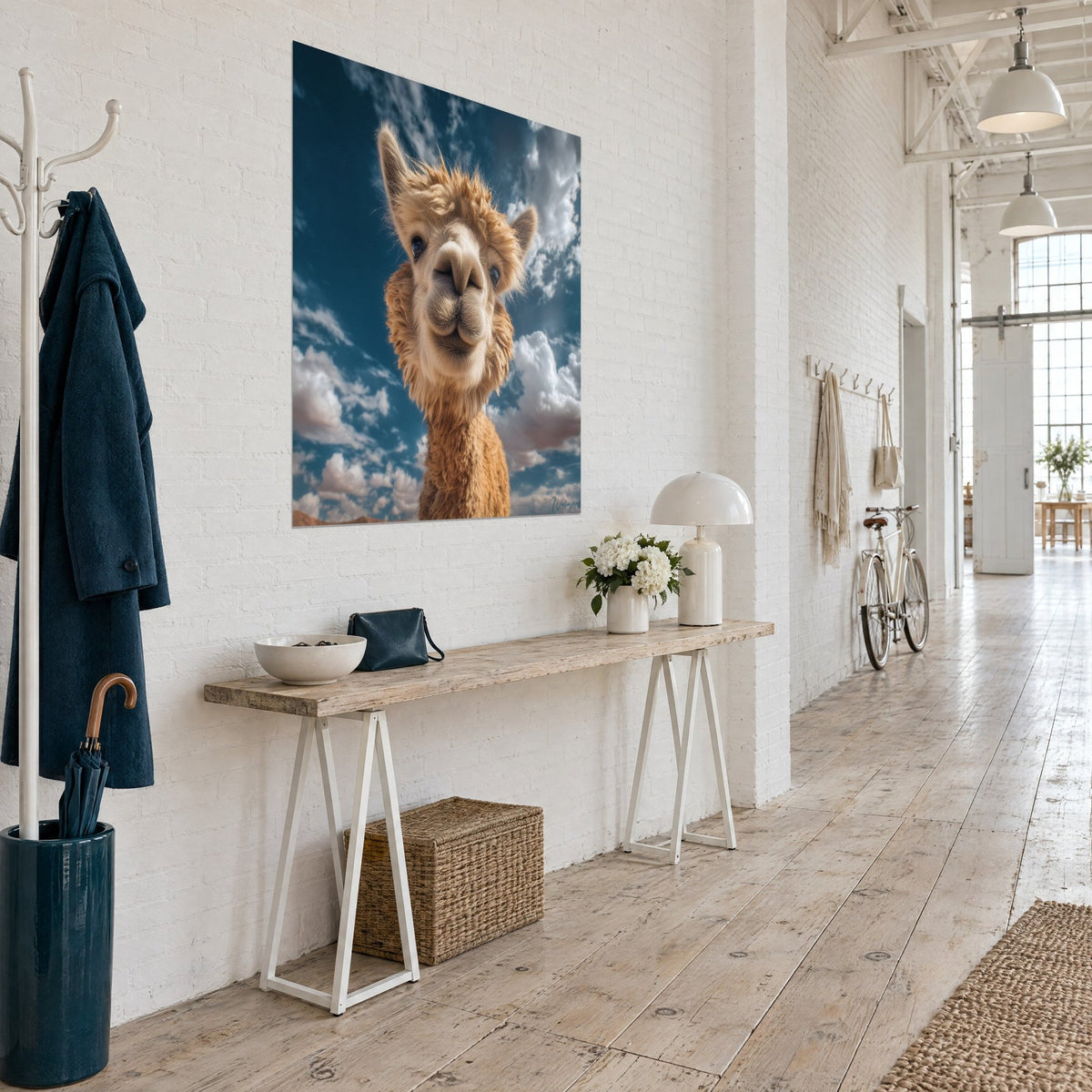 Wall art of a llama with caramel fleece and a cream-colored muzzle, white clouds on a deep blue background, three-quarter view in a loft
