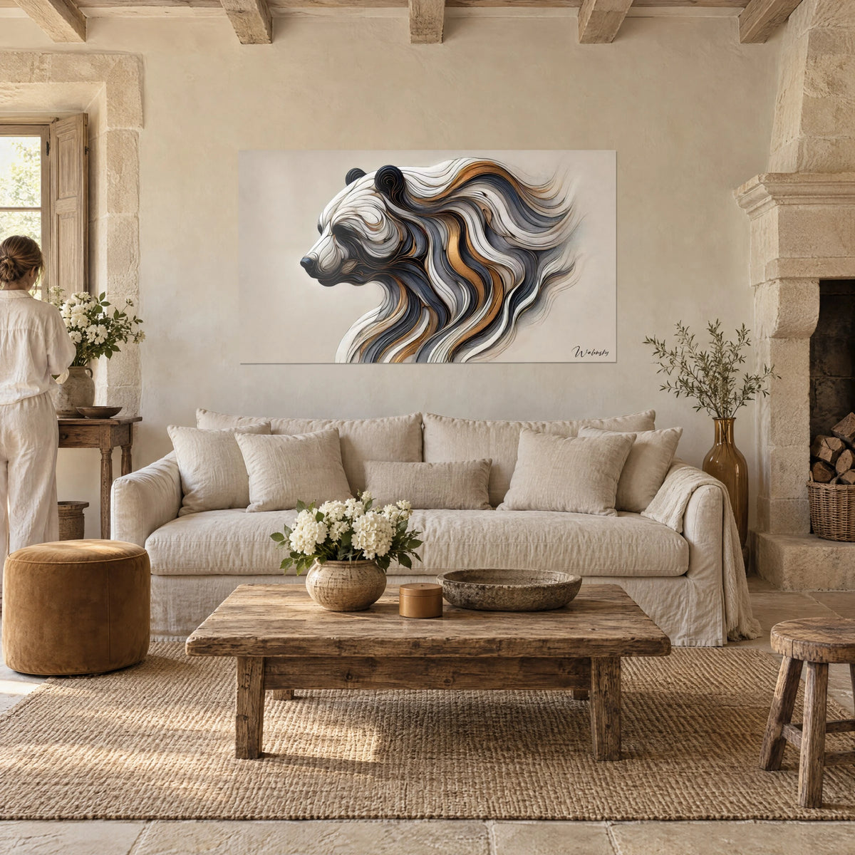 Wall art stylized bear in white, grey and copper ribbons, left profile, with a woman seen from behind, above a sofa in a bright living room