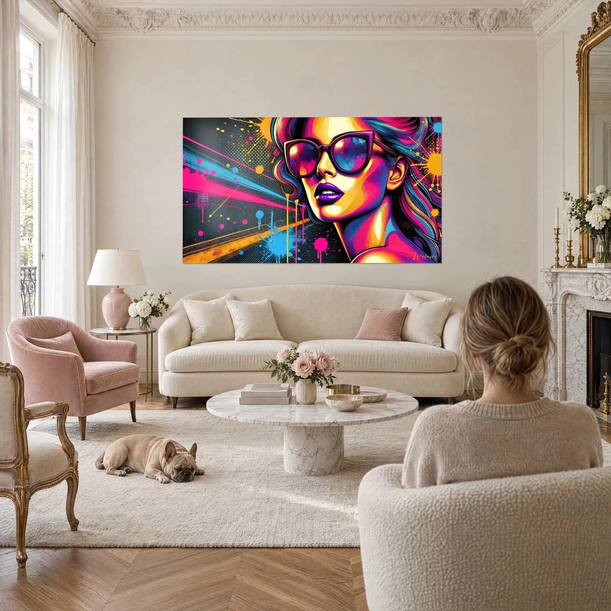Wall art pop art portrait of a woman in black sunglasses and violet lips, in fuchsia, pink and yellow, above a sofa in a bright living room
