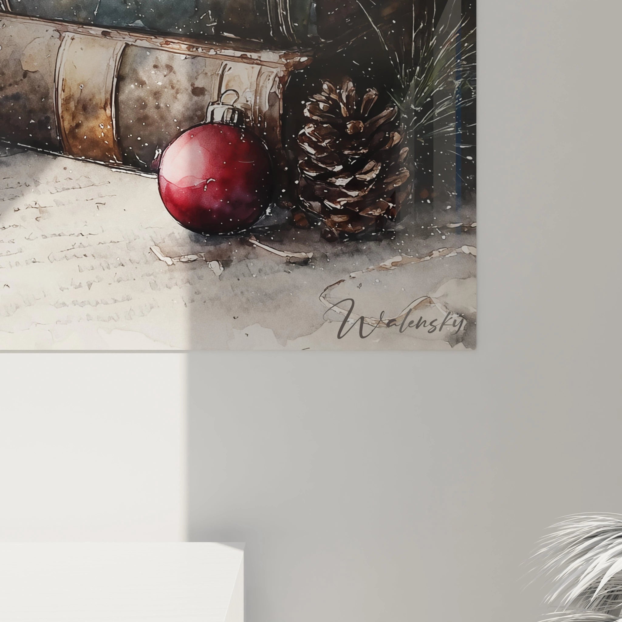 Tableau mural Noël livres avec une décoration de boule rouge et des pommes de pin sur une surface neutre
