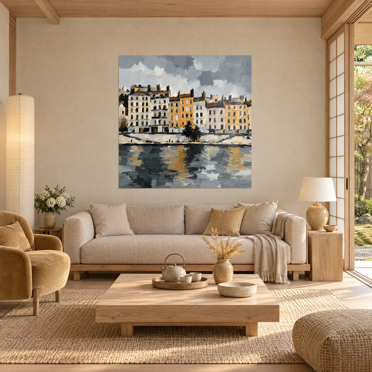 Quadro facciate lionesi in ocra e crema, cielo grigio a spatola, riflessi dorati sull'acqua, sopra un divano in un soggiorno luminoso