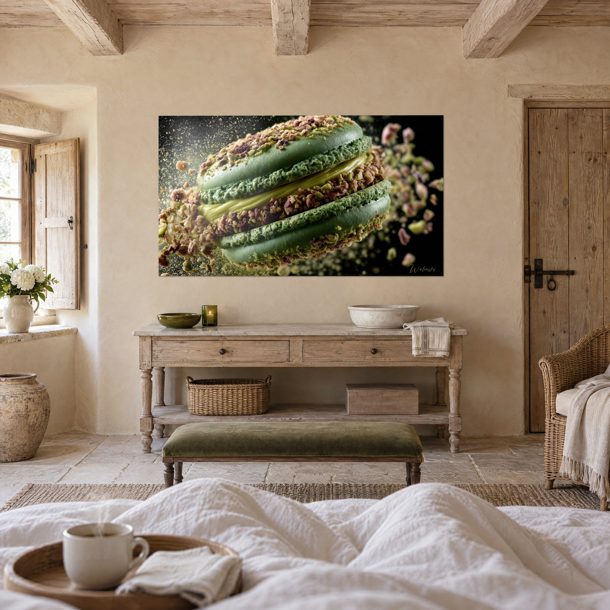 Wall art green pastry with rosy brown pistachio flecks, golden cream at the centre, above a bed in a light bedroom