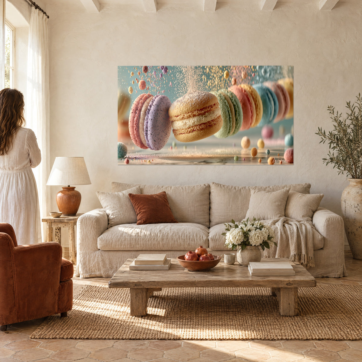 Wall art of beige macaron with cream layers suspended among mauve and pink shells, icing sugar, hung above a sofa in a bright living room