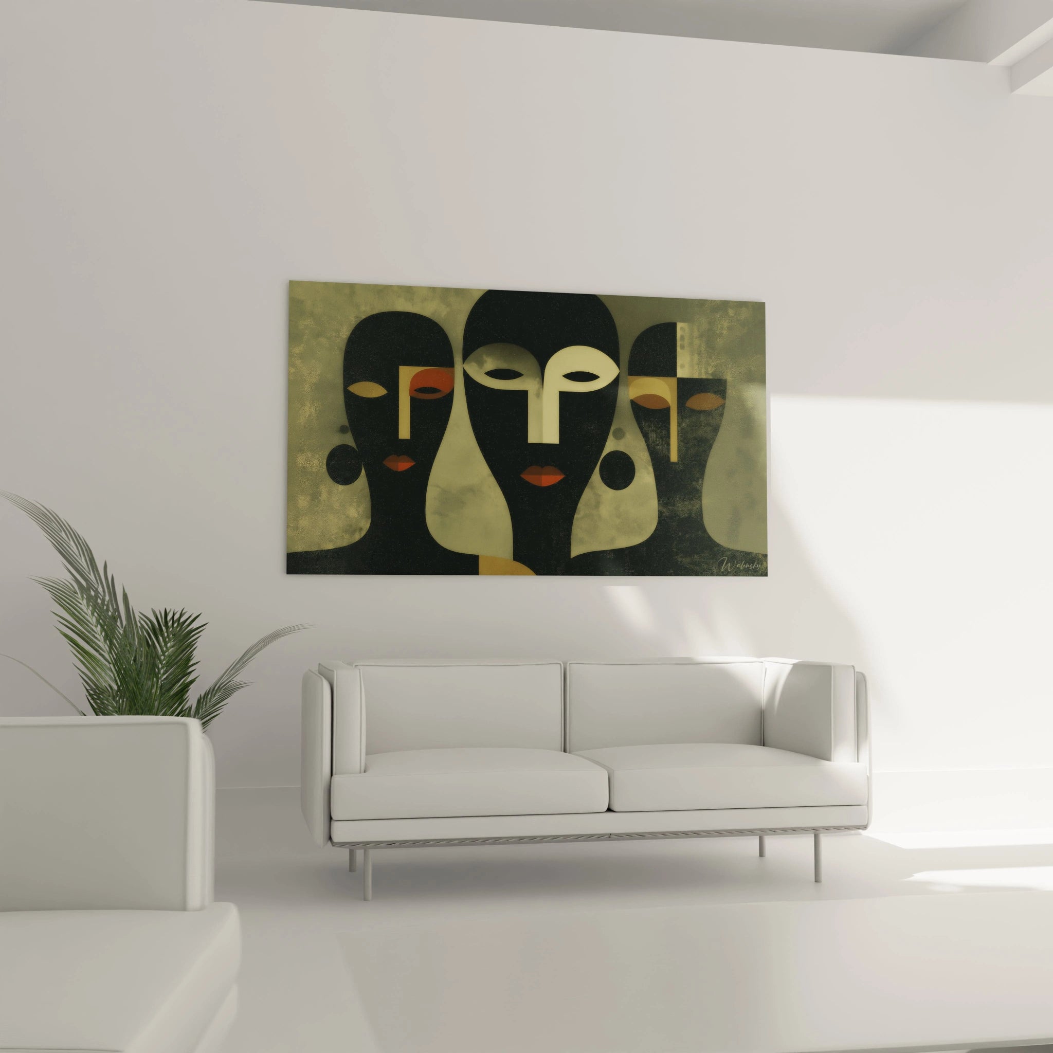 tableau art tribal moderne Walensky trois visages stylisés verts et noirs au dessus d un canapé blanc