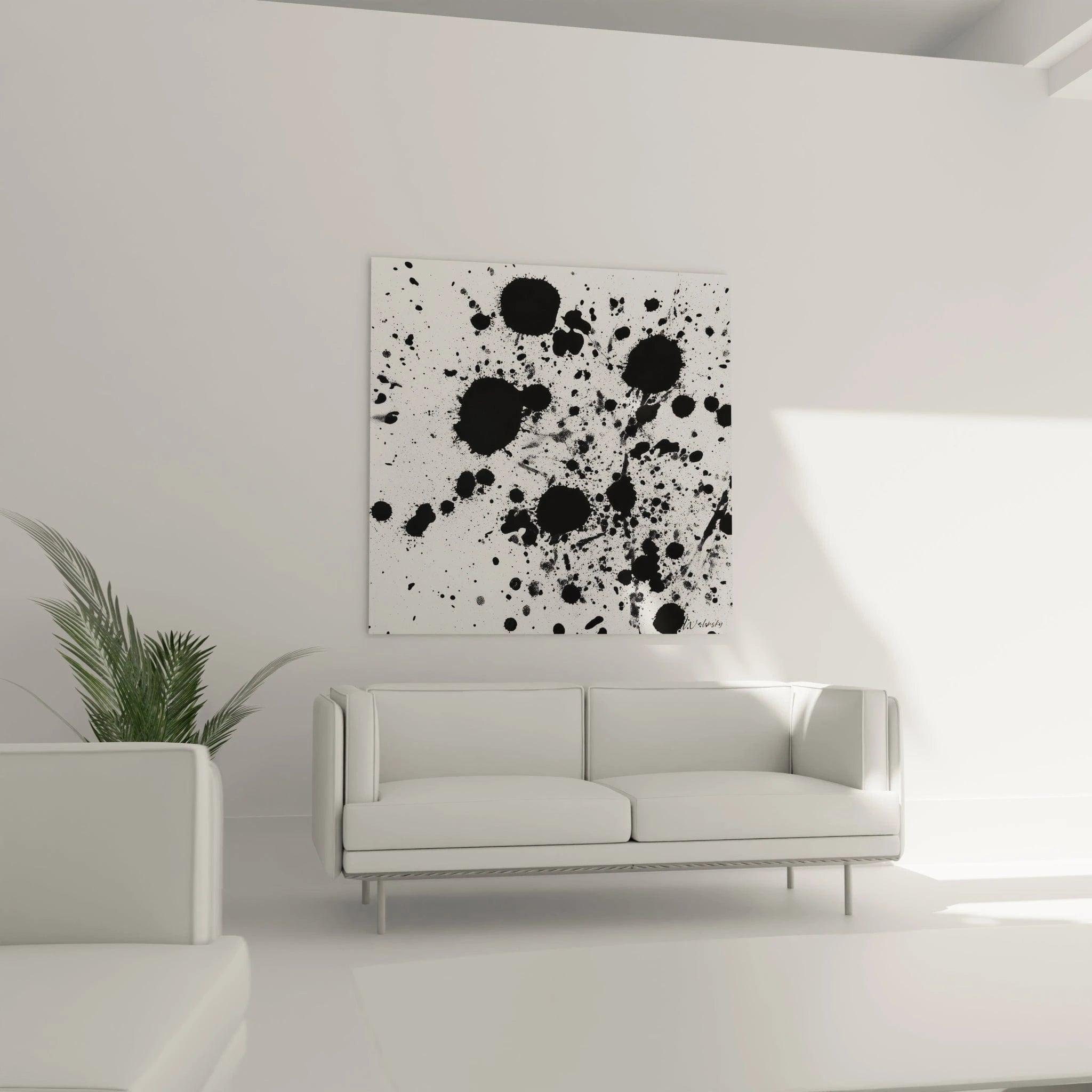 Tableau tacheté noir et blanc Walensky accroché au mur d'un salon moderne avec un canapé blanc