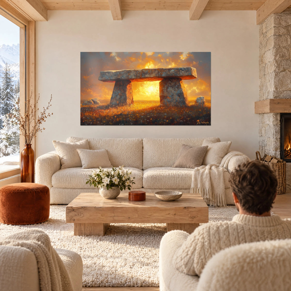 Wall art grey stone dolmen under an orange and golden sky, couple seen from behind, above a sofa in a bright living room