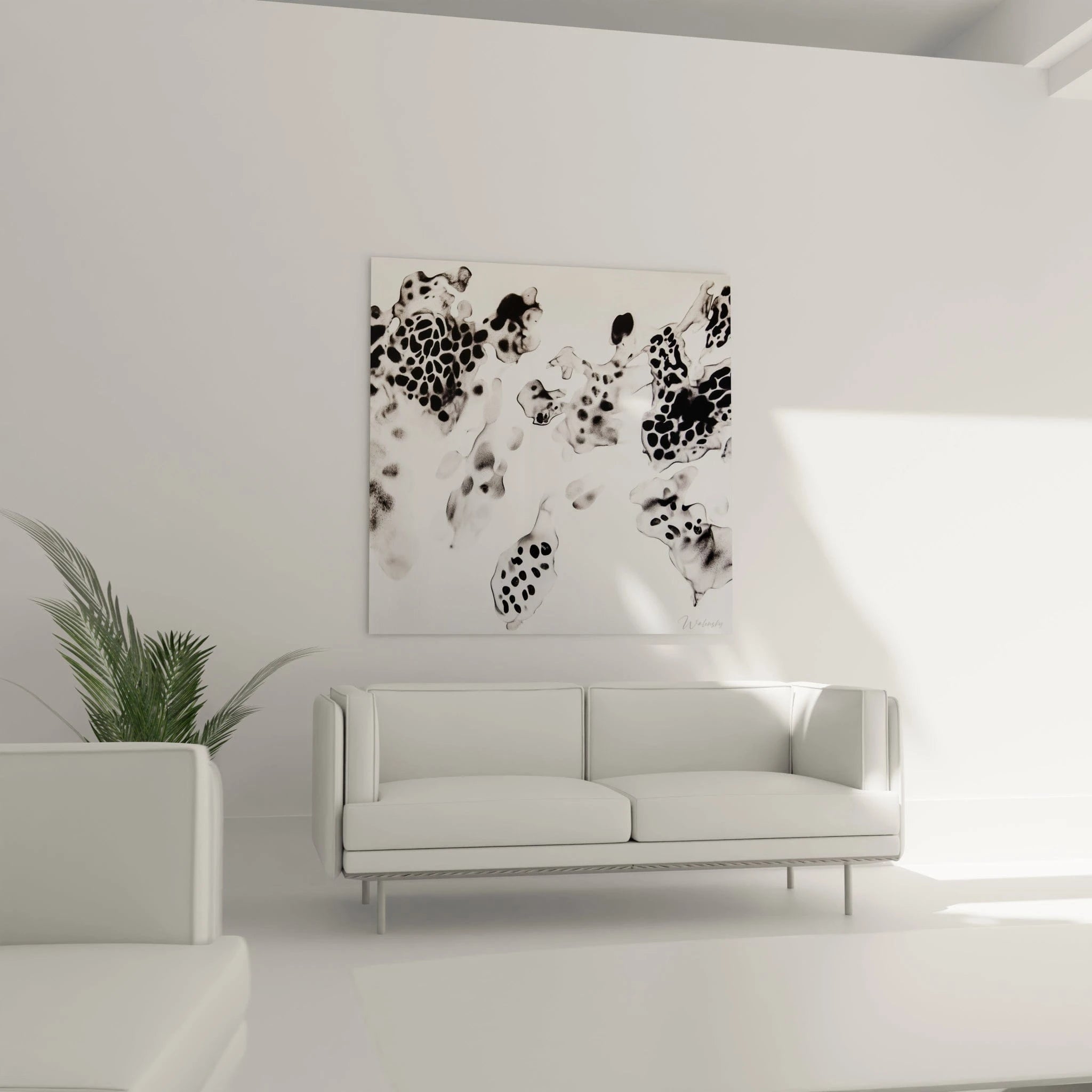 Tableau tacheté noir et blanc de Walensky décorant un salon moderne avec un canapé blanc