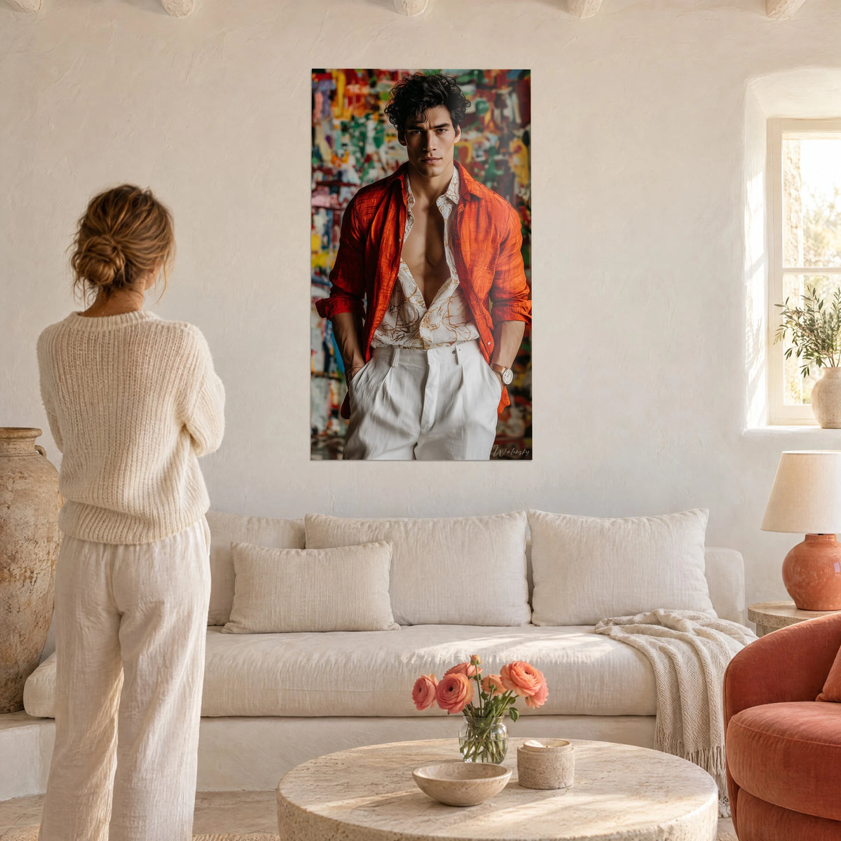 Tableau jeune homme brun en chemise orange ouverte, pantalon blanc, fond de graffitis colorés, au-dessus d'un canapé dans un salon lumineux