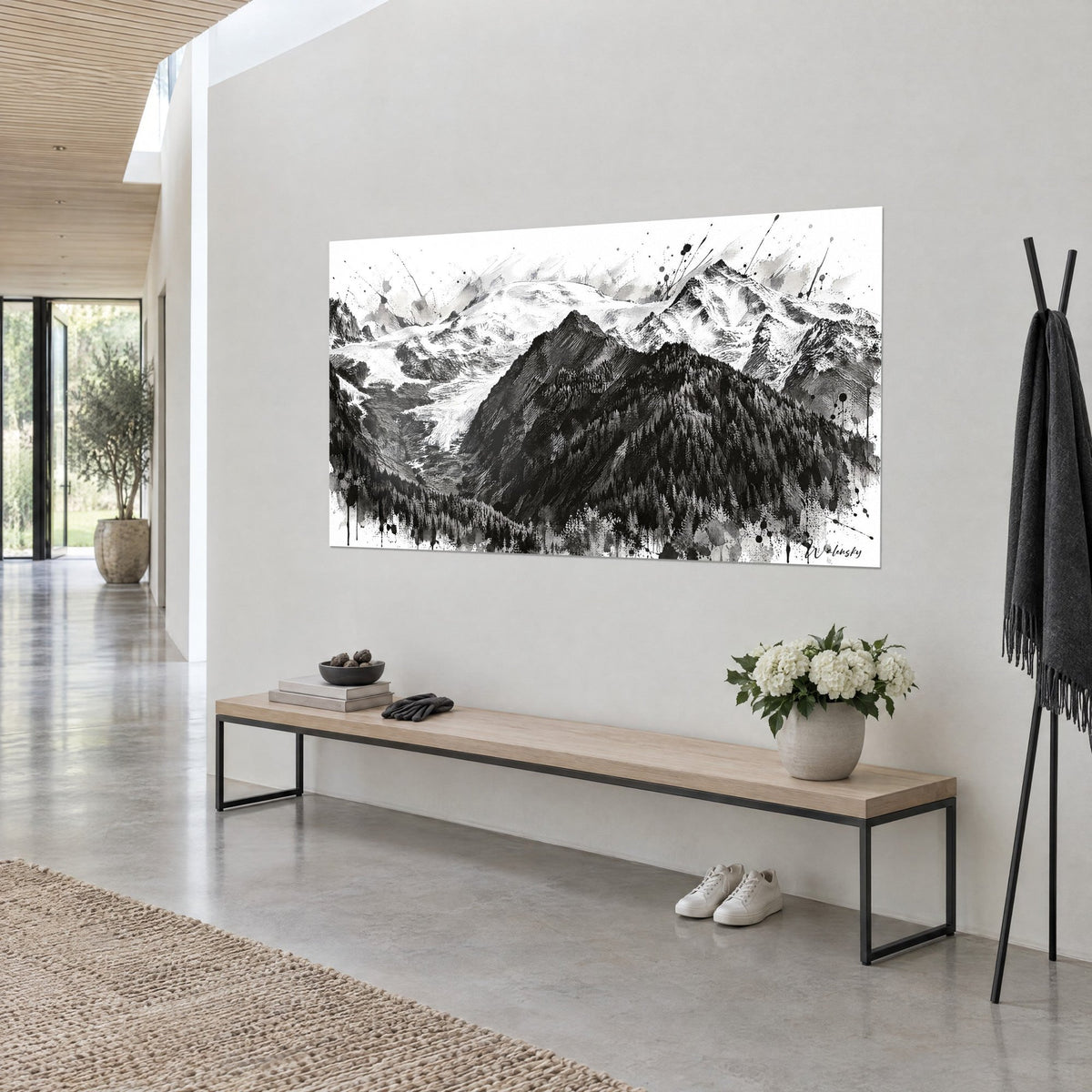 Wall art of a hatched granite summit, white snowfields and grey splashes, hung on a light wall beside a wooden bench