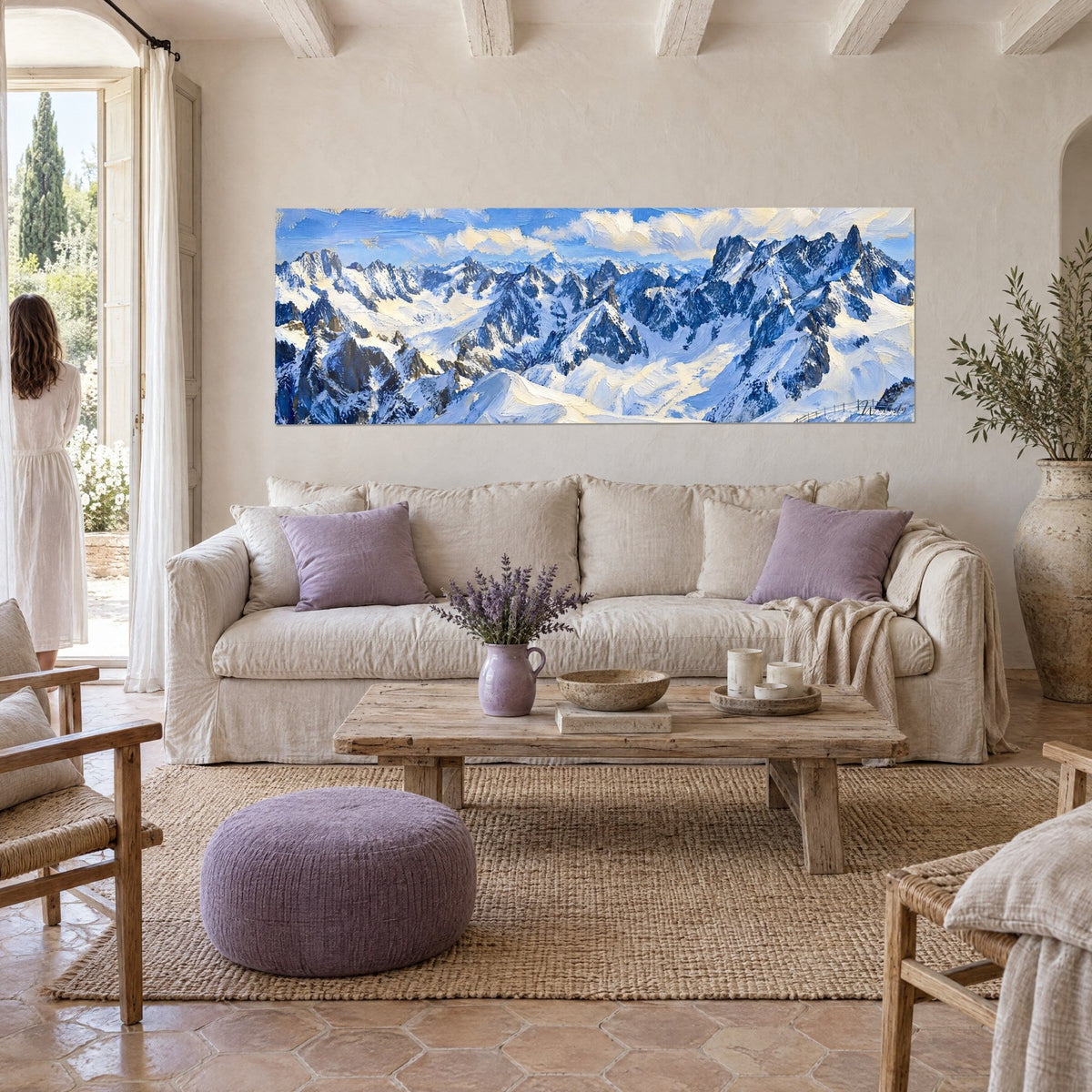Wall art of a massive alpine mountain with snowy ridges in slate blue and cream white, thick brushstrokes, above a sofa in a bright living room