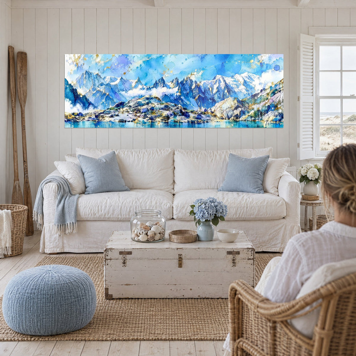 Wall art massive alpine mountain with snowy needles in glacier blue and gold, turquoise lake, above a sofa in a bright living room