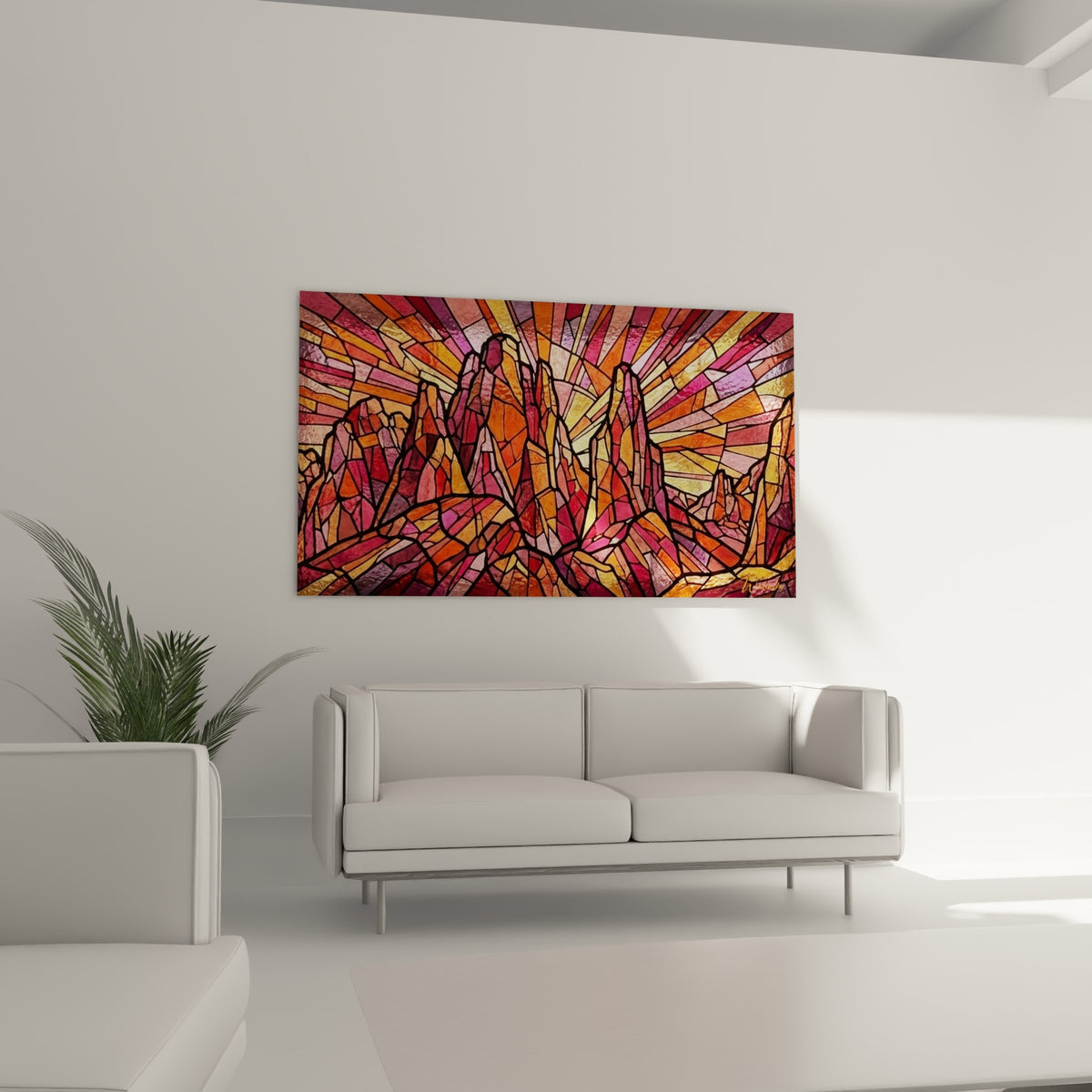 Crêtes rocheuses orangées et rose vif en mosaïque graphique, au-dessus d'un canapé dans un salon lumineux