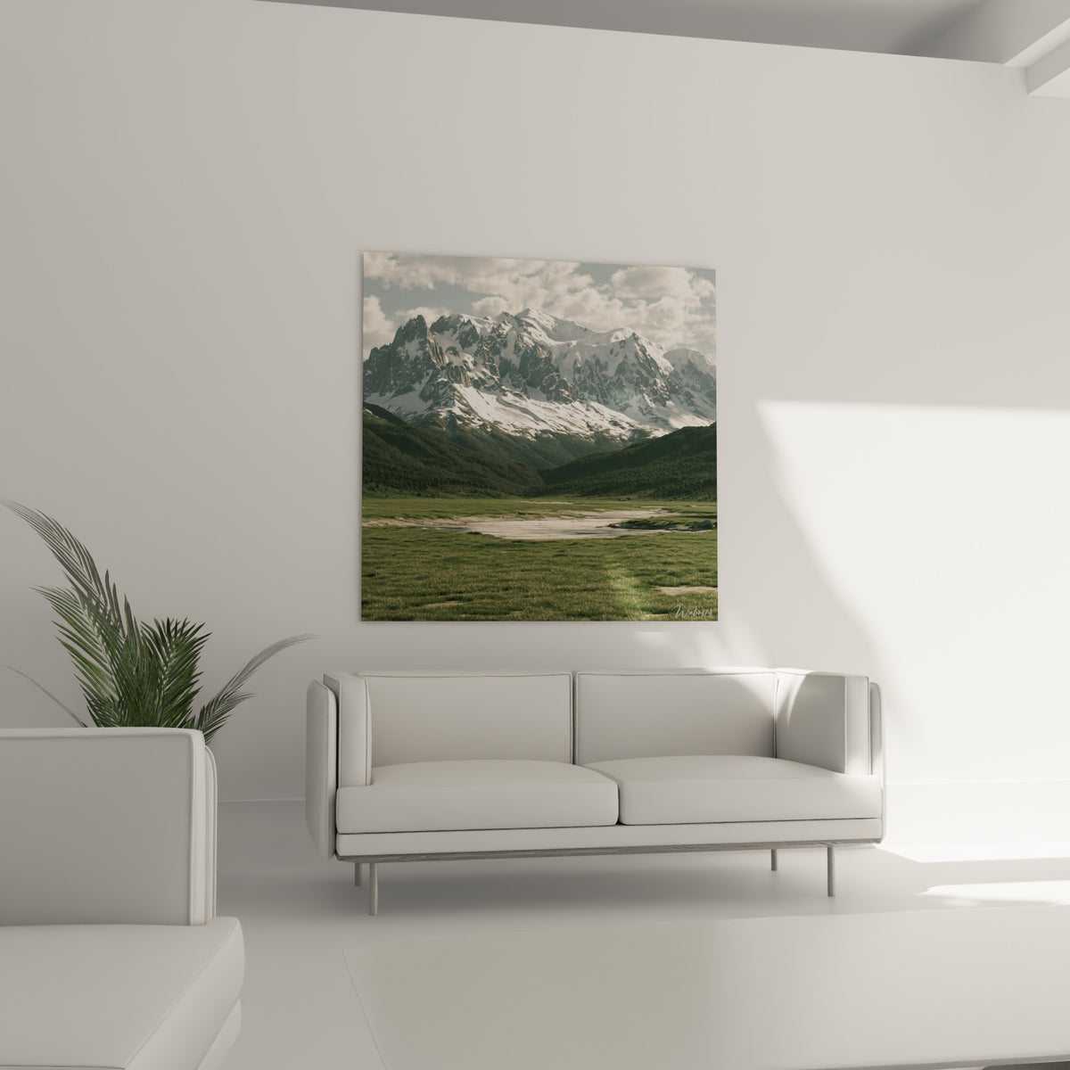 Rivière sinueuse traversant une vallée verte sous des cimes enneigées, au-dessus d'un canapé dans un salon lumineux