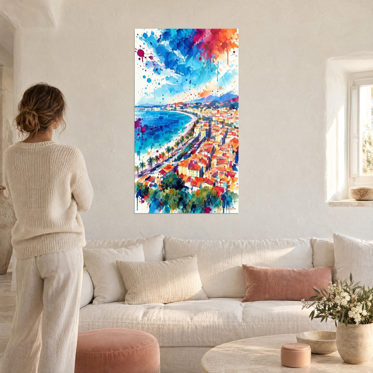 Wall art of Nice panorama in watercolor, orange rooftops and blue sea, red splashes, woman seen from behind, above a sofa in a bright living room