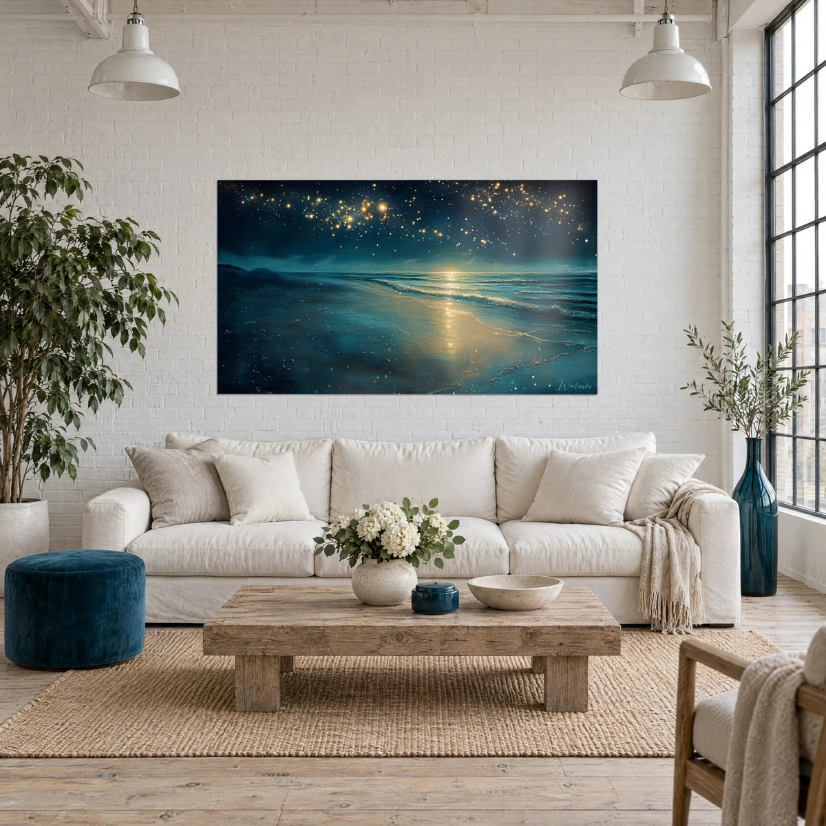 Wall art night beach with golden reflections, starry deep navy sky, above a sofa in a bright living room