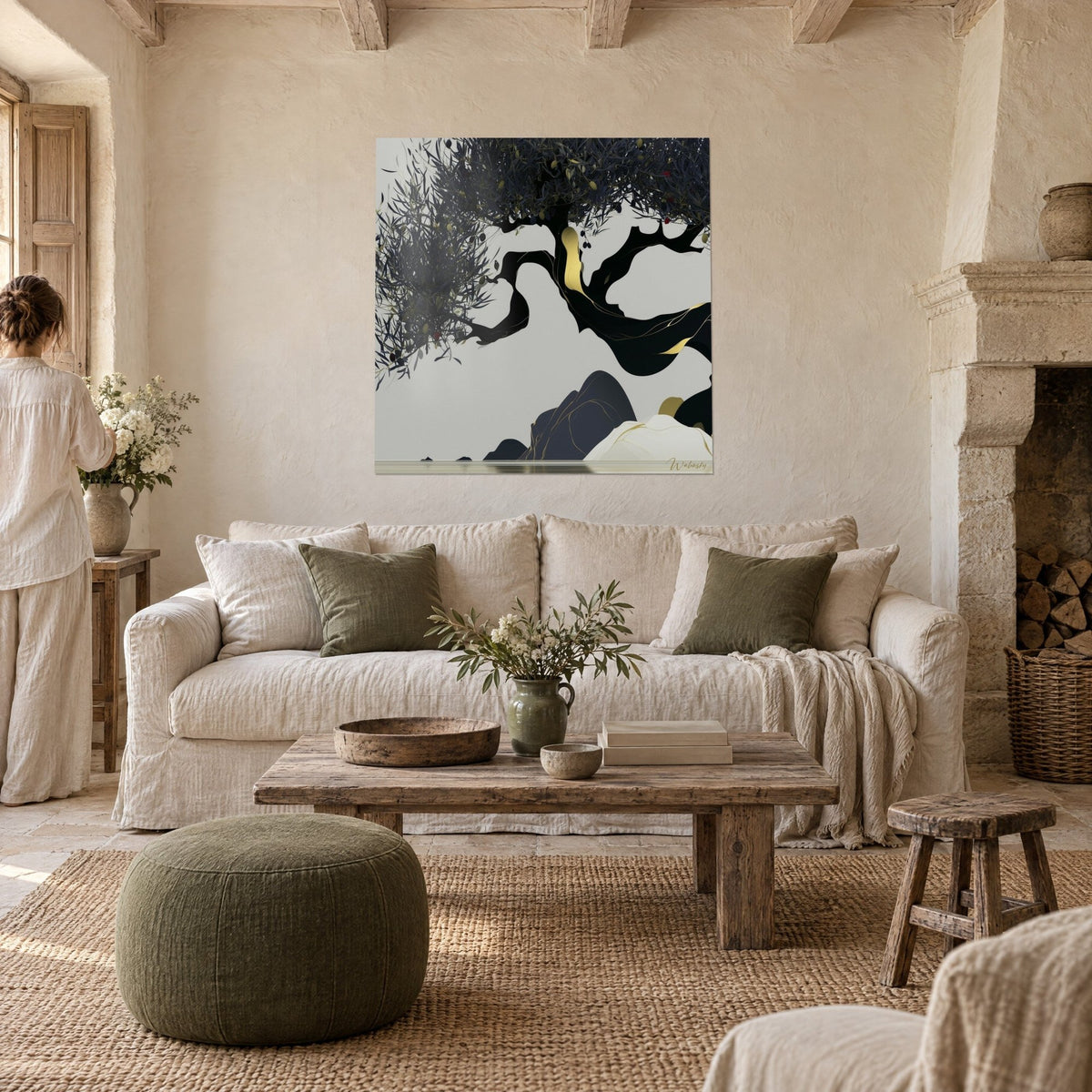 Wall art twisted black olive tree with golden veins on pearl grey background, a woman seen from behind, above a sofa in a bright living room