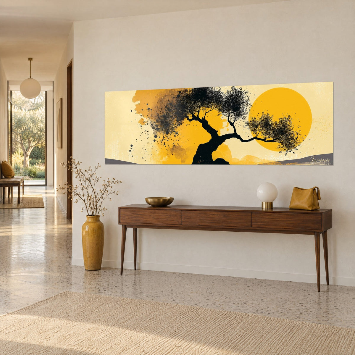 Wall art black tree with tapering branches, ochre splashes and golden sun on a cream background, hung above a wooden console