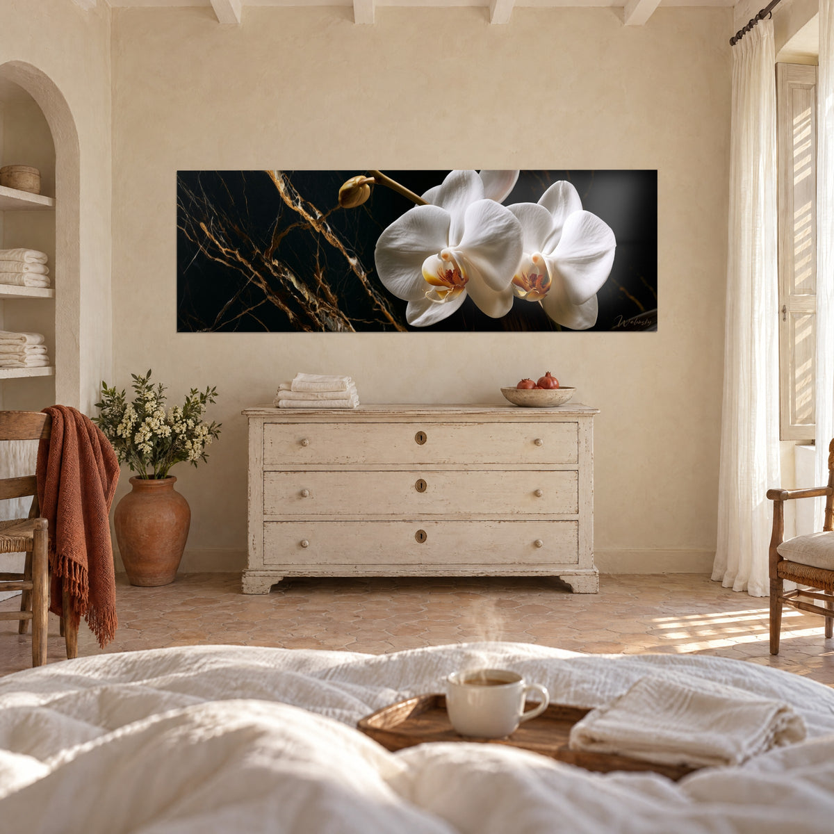 Quadro fiori di orchidea dai petali madreperlacei e venature dorate su marmo scuro, sopra un letto in una camera luminosa