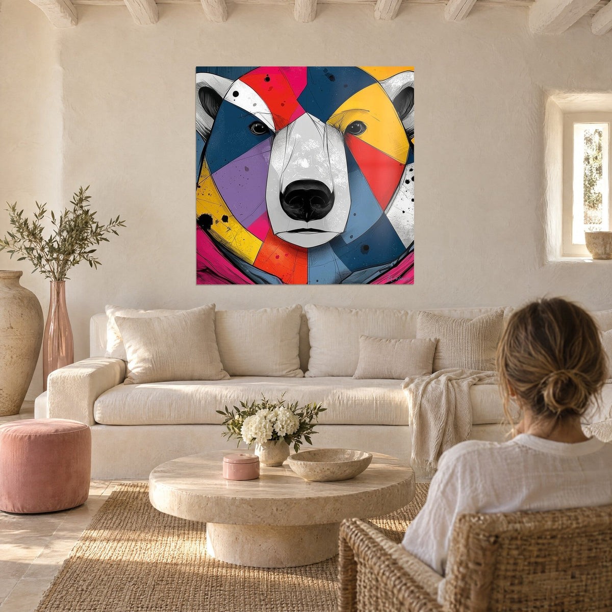Wall art polar bear in saffron yellow and navy blue facets, white muzzle, a woman seen from behind, above a sofa in a bright living room