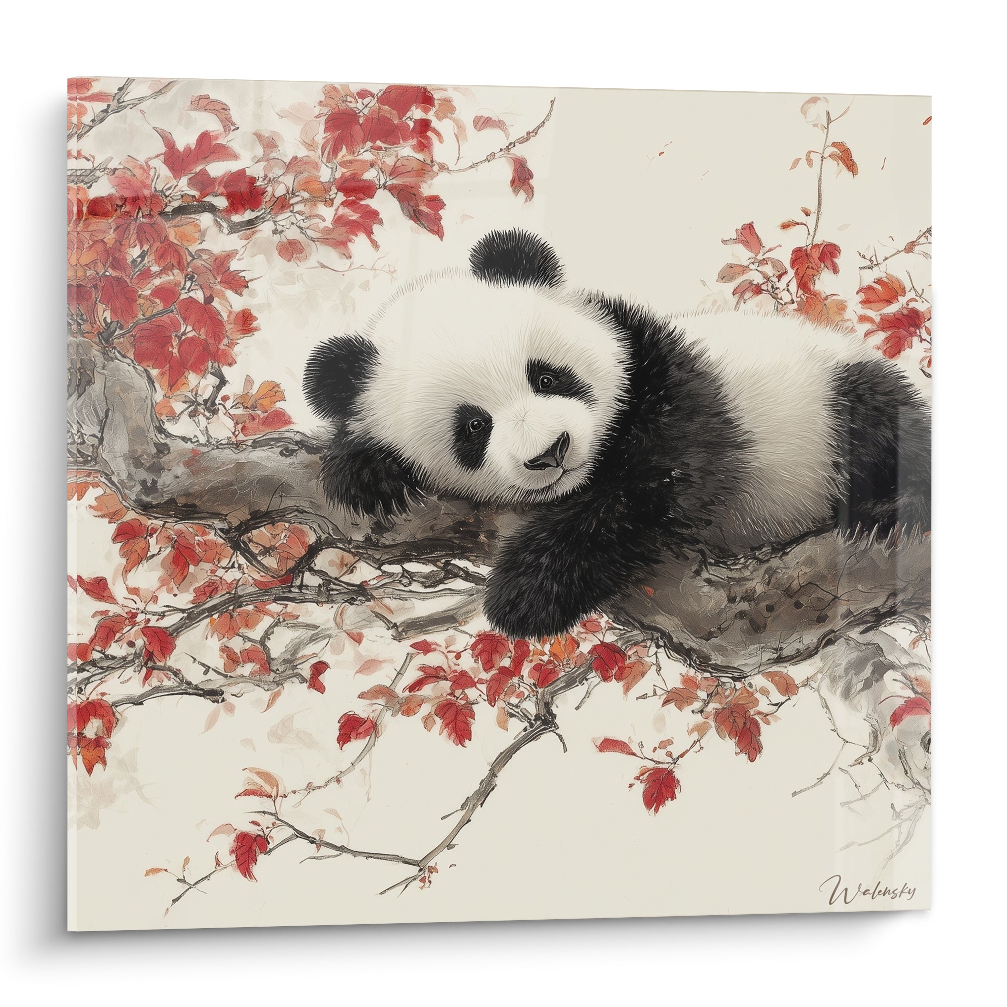 Panda noir et blanc allongé sur une branche parmi des feuilles rouges et grises