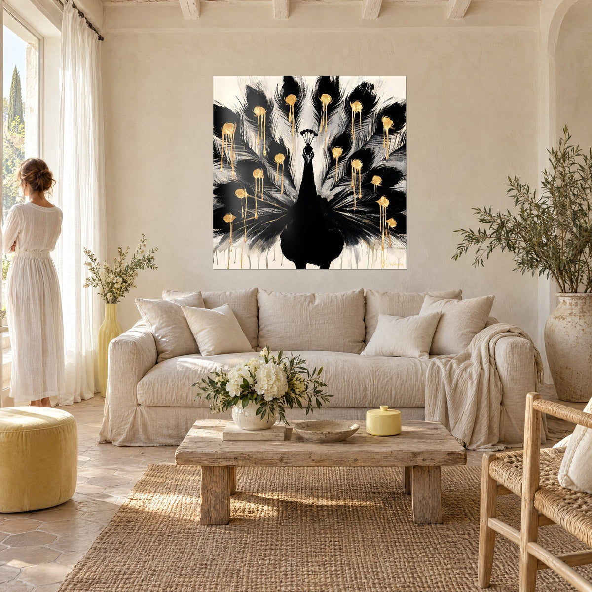 Wall art black peacock fanning its tail, golden eyespots dripping over ivory background, above a sofa in a bright living room
