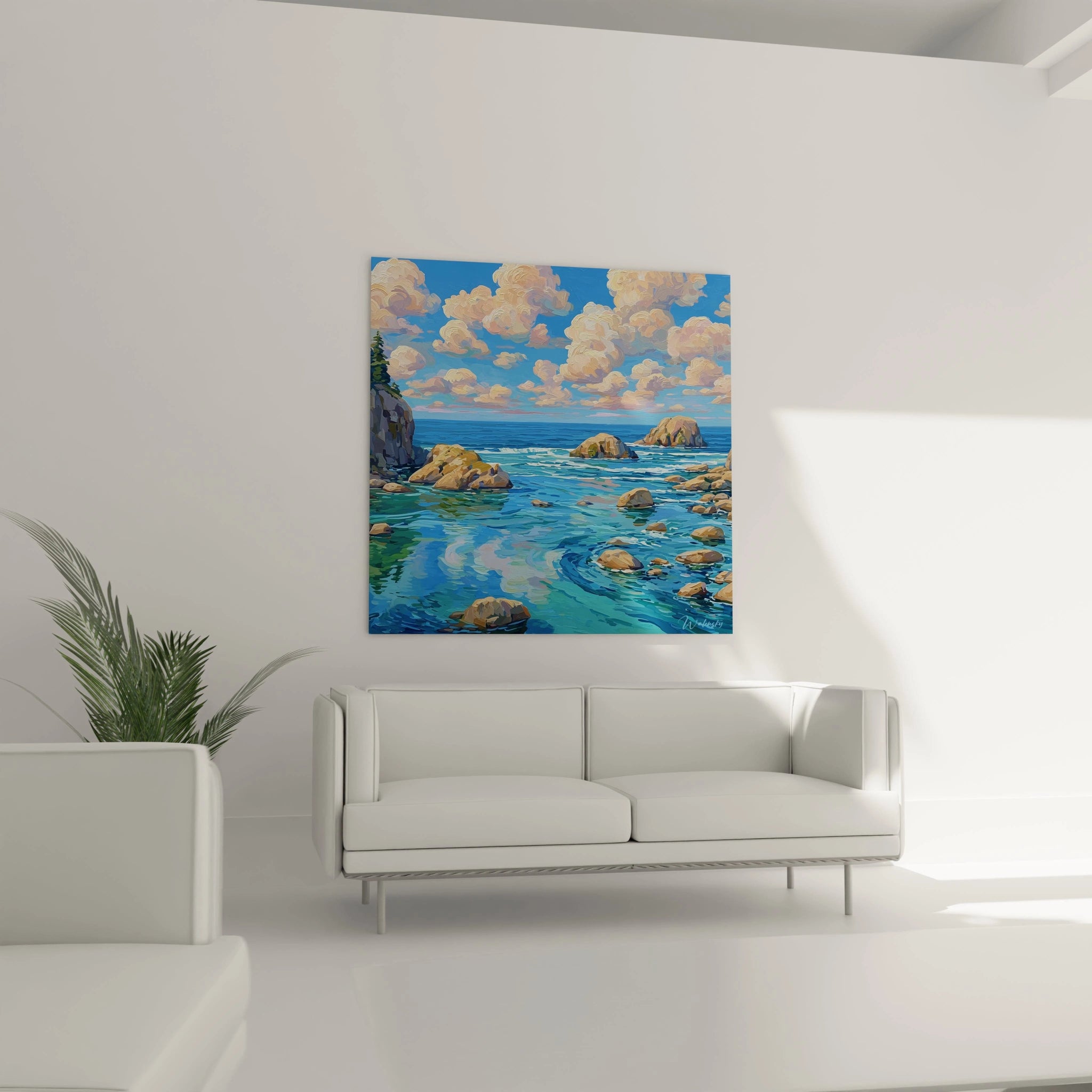tableau paysage marin Walensky accroché au mur au dessus d un canapé blanc montrant rochers mer turquoise et ciel nuageux