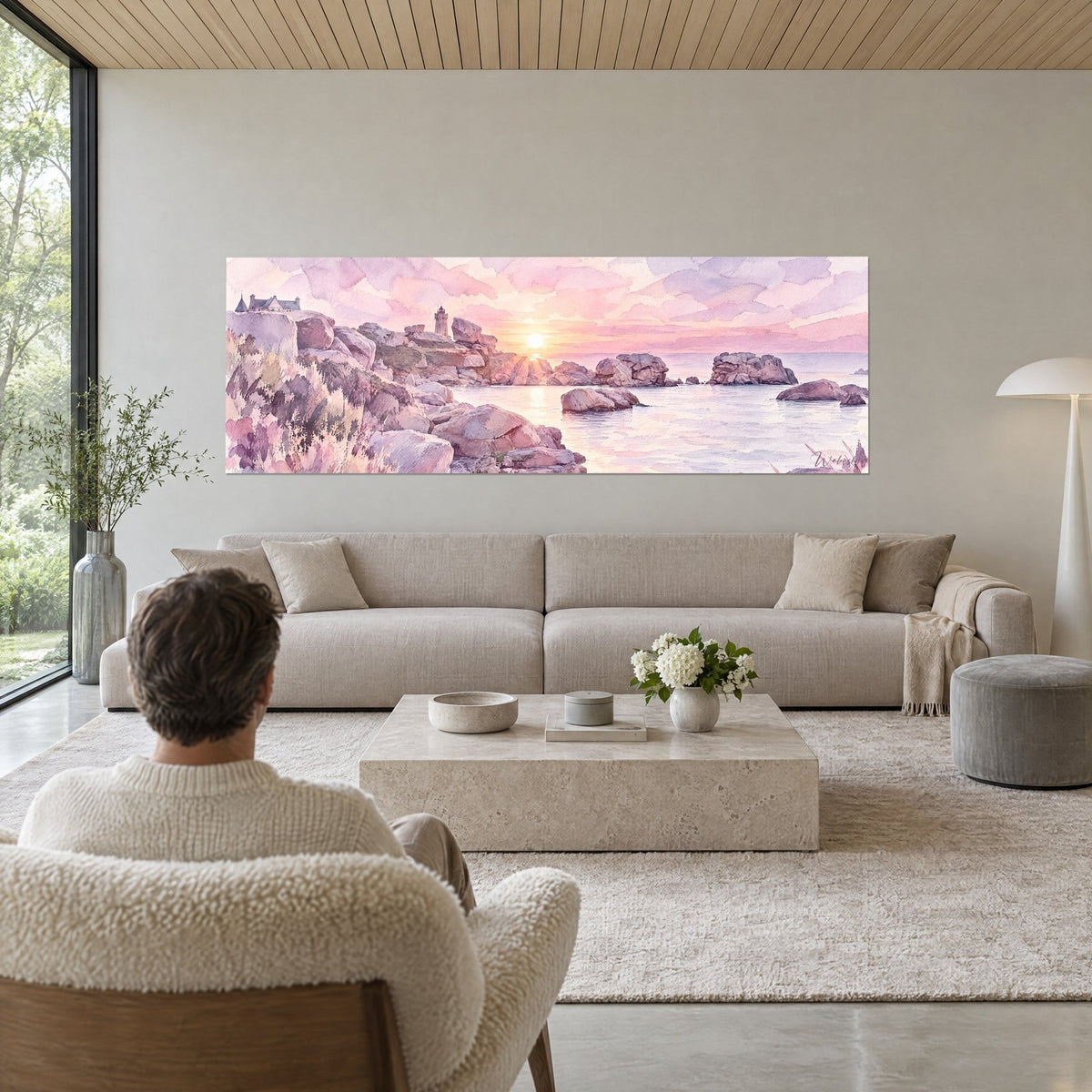 Tableau côte rocheuse de Perros-Guirec en aquarelle, rochers mauves et ciel rose, au-dessus d'un canapé dans un salon lumineux
