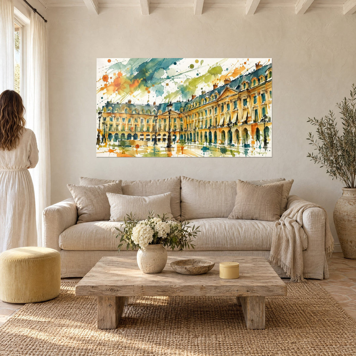 Wall art Haussmann-style façade in ochre and teal watercolour, black street lamps, woman seen from behind above a sofa in a bright living room