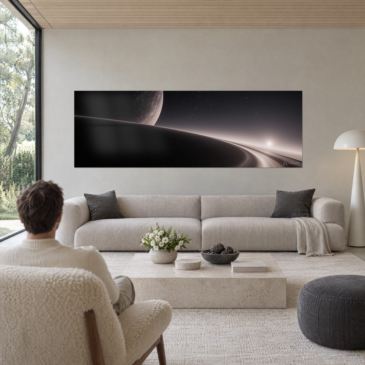 Tableau lune cendrée gravée de cratères au-dessus d'une dune noire sous un halo rose, au-dessus d'un canapé dans un salon lumineux