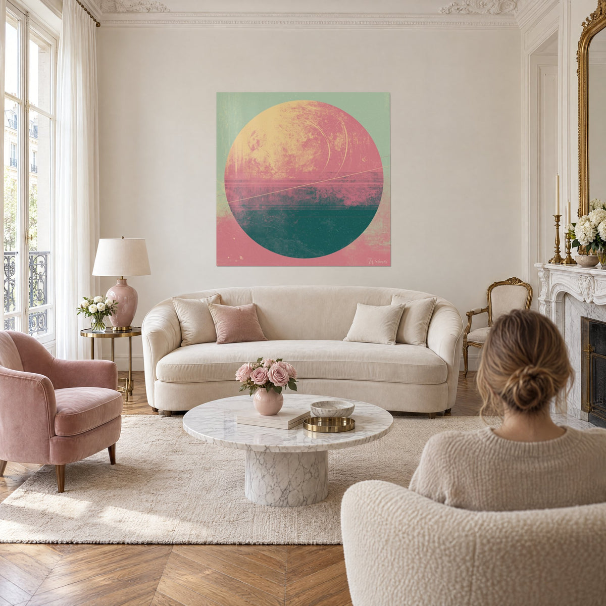 Wall art planet in pink and pale yellow on a sage green background, diagonal gold line, above a sofa in a bright living room