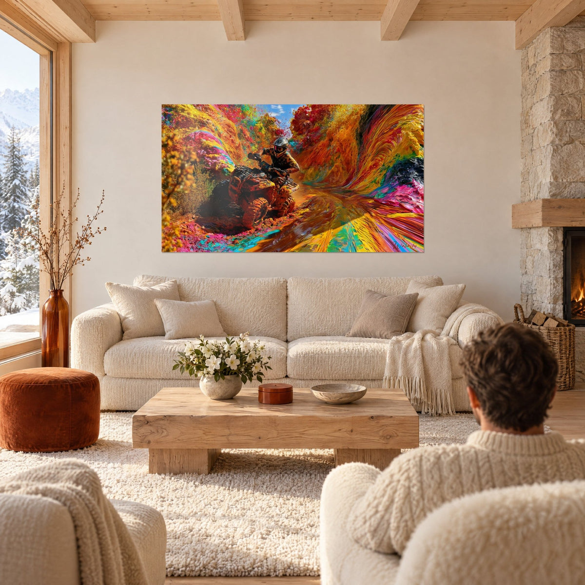 Wall art helmeted quad rider charging through an orange and turquoise paint canyon, above a sofa in a bright living room